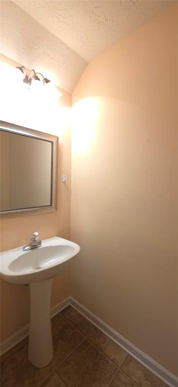 465 Little Creek Road Southeast Lawrenceville, GA 30045 - Photo 5 of 13 a bathroom with a sink and a mirror