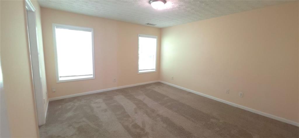 465 Little Creek Road Southeast Lawrenceville, GA 30045 - Photo 7 of 13 an empty room with windows and closet