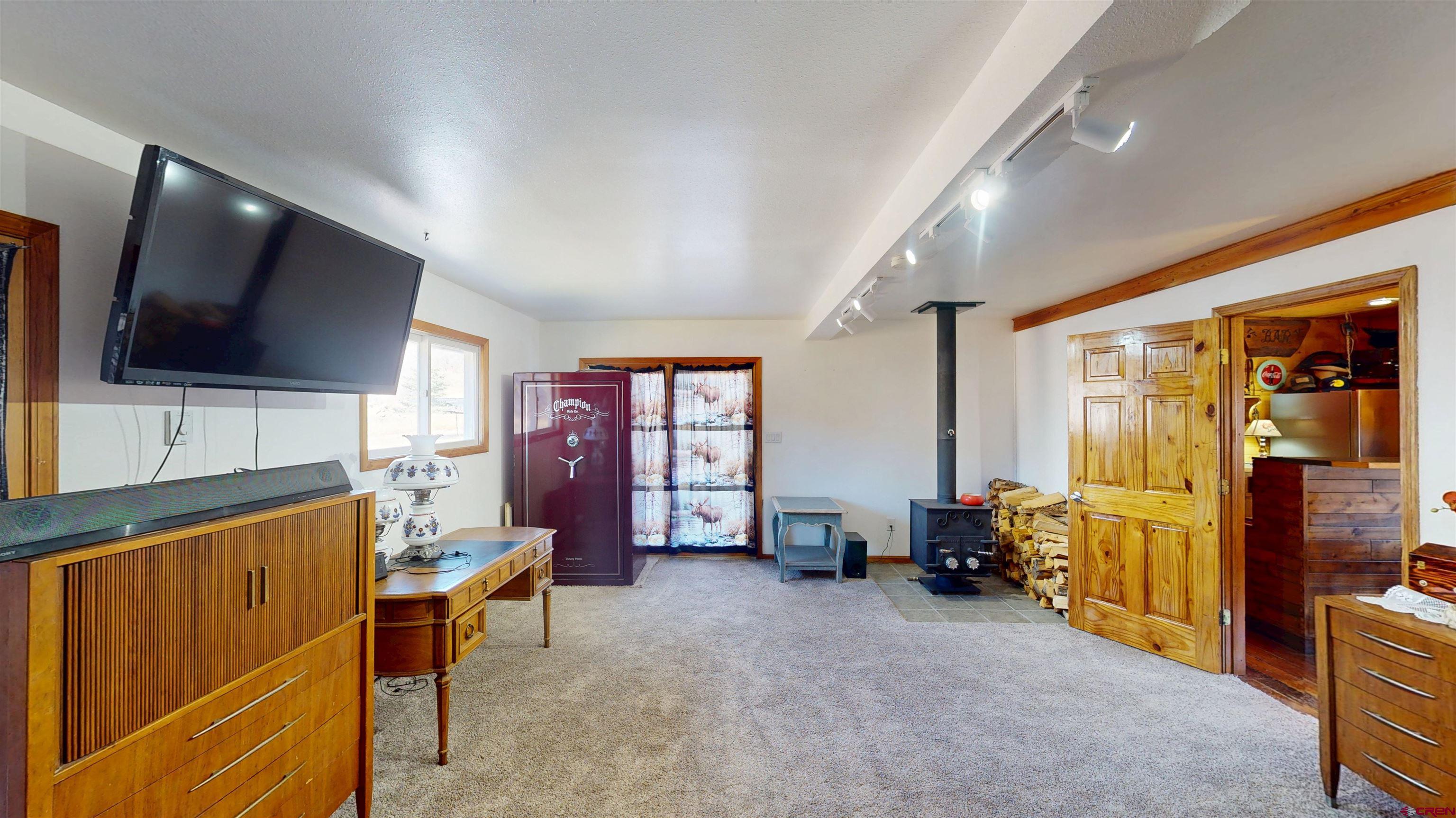 19253 Stevens Gulch Road Paonia, CO 81428 - Photo 17 of 43 a living room with furniture and a flat screen tv