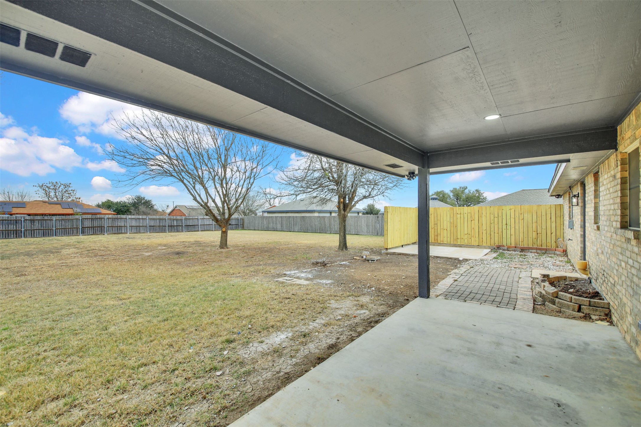 131 Meadow Valley Loop Jarrell, TX 76537 - Photo 25 of 32 Another view of the patio and the back yard - fully fenced