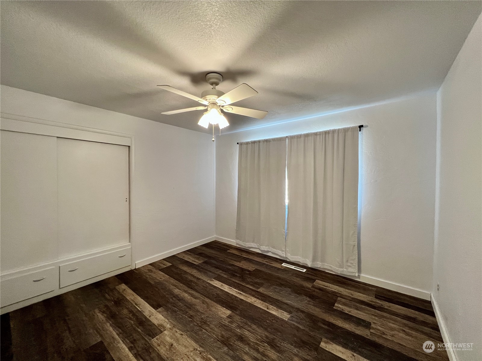 152 Jackson Road Pomeroy, WA 99347 - Photo 14 of 40 a view of a room with wooden floor and white walls