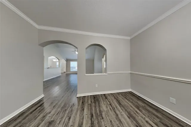 a view of empty room with wooden floor