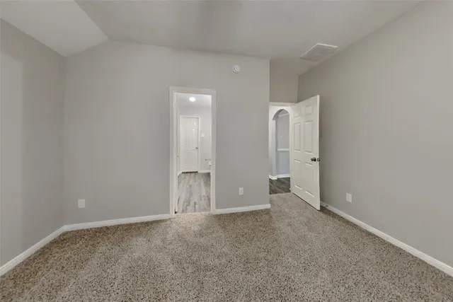 an empty room with closet and wooden tub