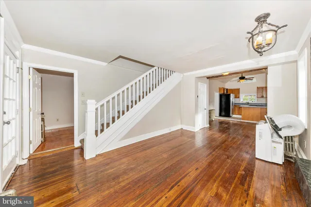 a view of a hallway with wooden floor and staircase