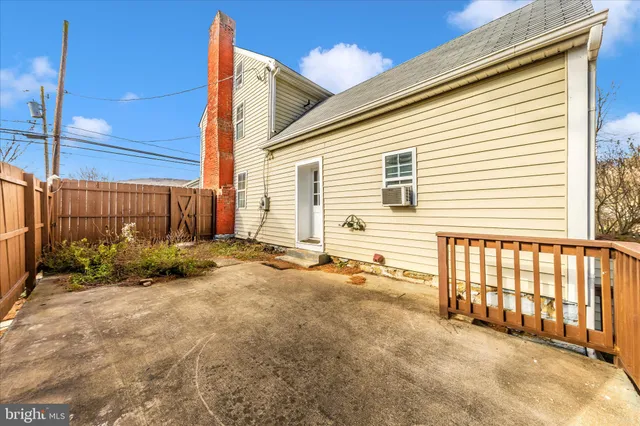 a view of a balcony with a floor to ceiling window and wooden floor