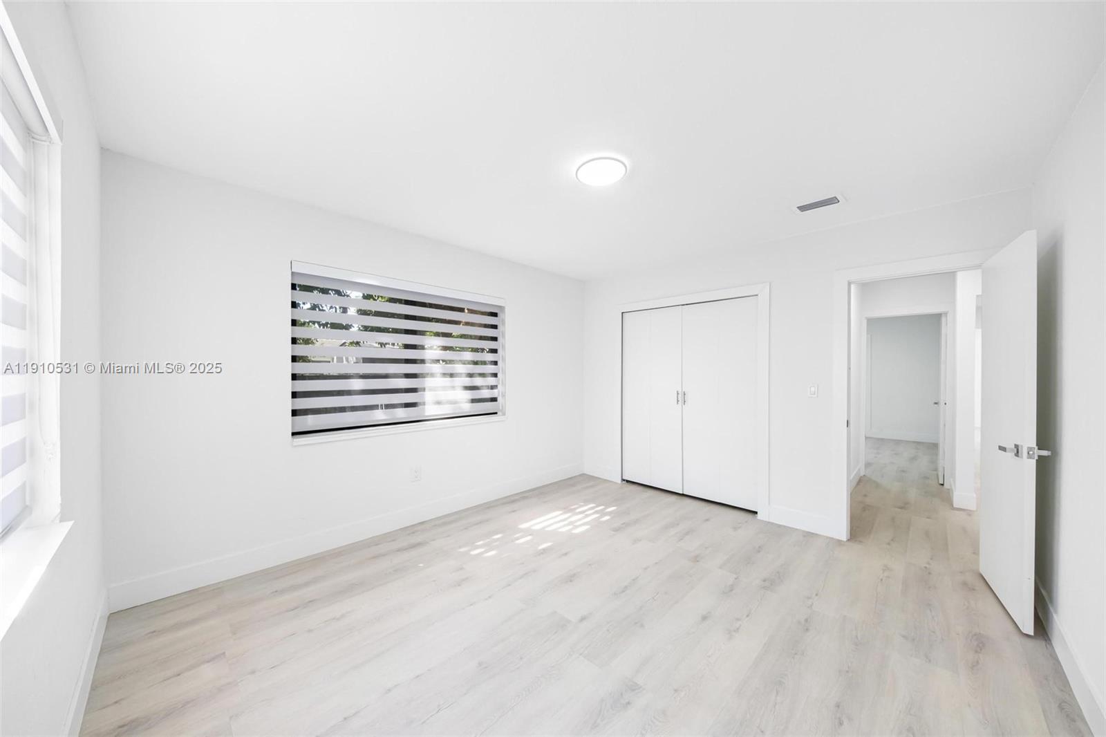 2250 Northwest 95th Street Miami, FL 33147 - Photo 16 of 26 a view of an empty room with wooden floor and a window