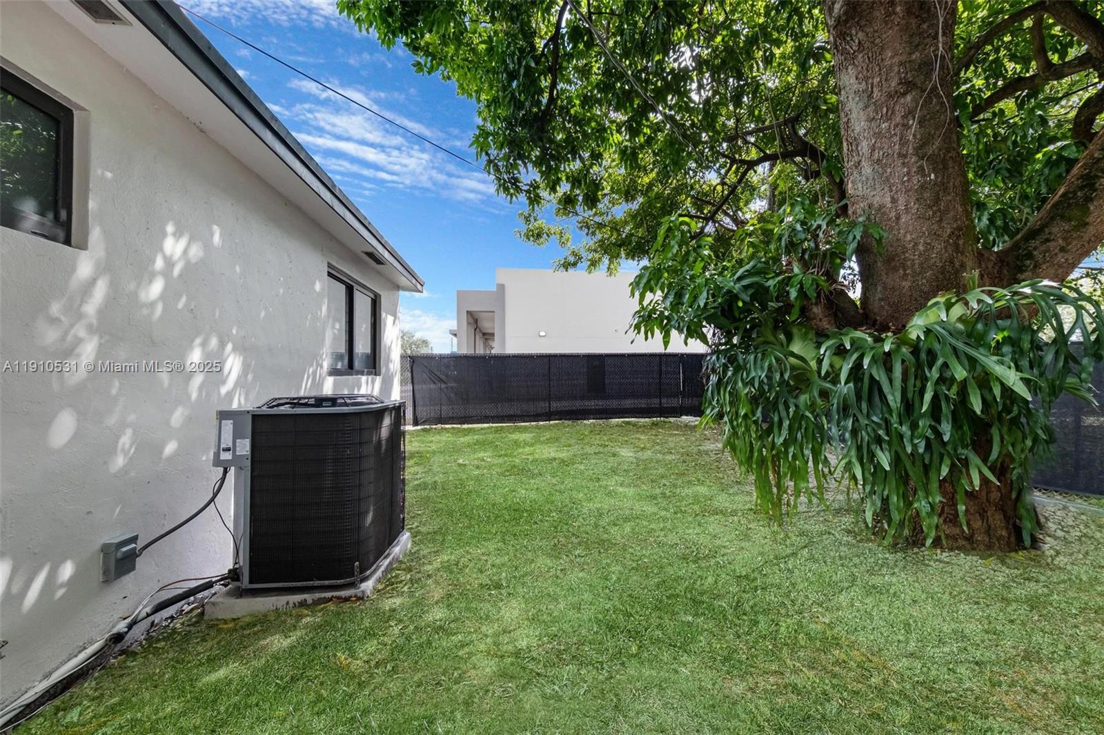 2250 Northwest 95th Street Miami, FL 33147 - Photo 25 of 26 a view of backyard with potted plants and a large tree