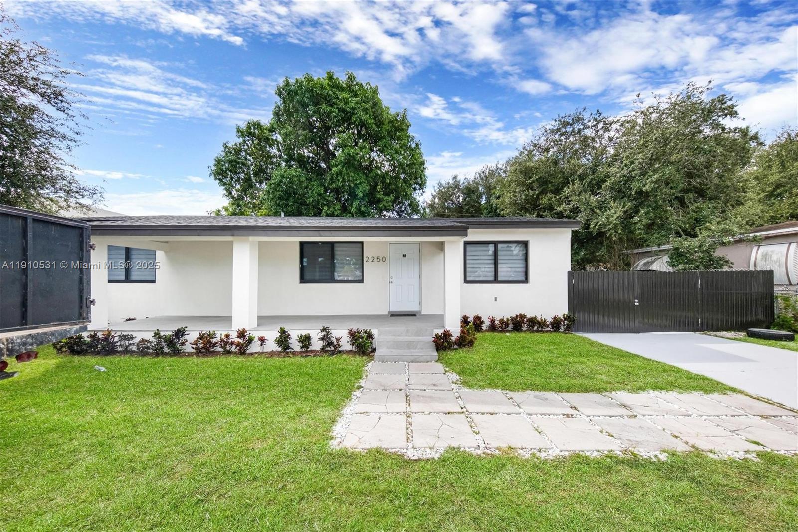 2250 Northwest 95th Street Miami, FL 33147 - Photo 3 of 26 a front view of house with yard