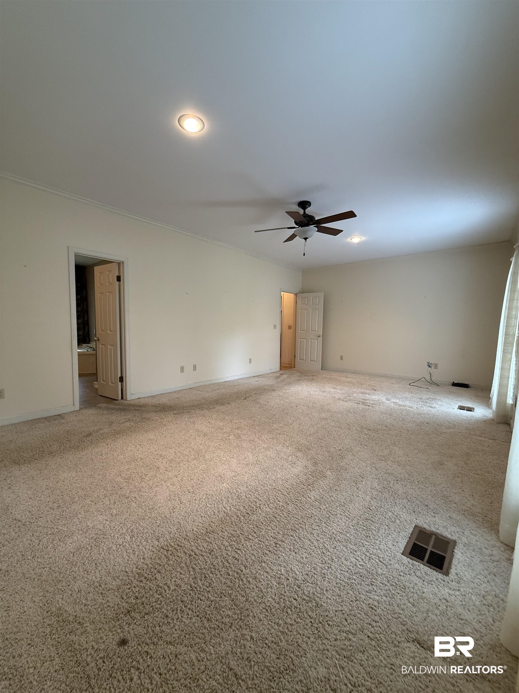 295 Norwood Road Monroeville, AL 36460 - Photo 9 of 32 Carpeted spare room featuring a ceiling fan and baseboards