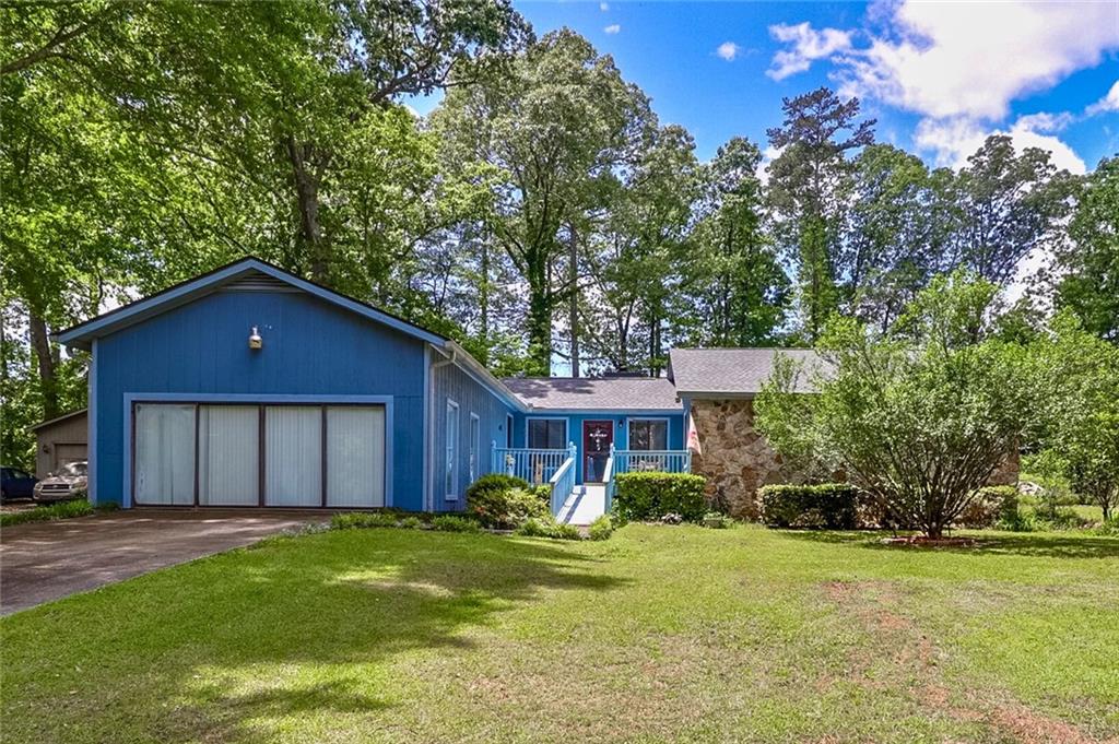 3739 Lake Carlton Road Loganville, GA 30052 - Photo 1 of 1 a front view of a house with garden