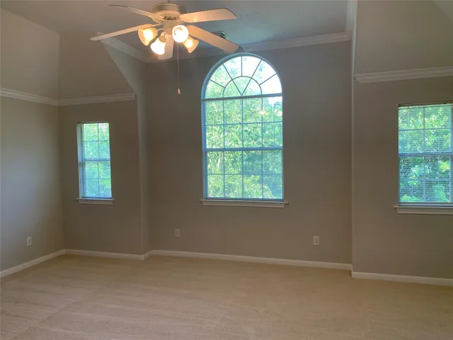an empty room with a window and a chandelier
