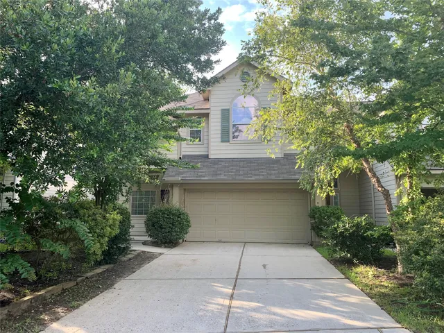 a front view of a house with plants