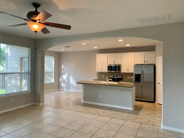 a kitchen with stainless steel appliances granite countertop a sink and a stove