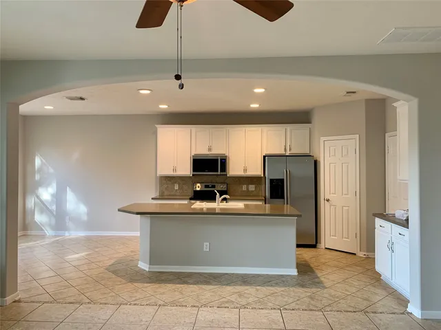 a kitchen with stainless steel appliances a sink and refrigerator