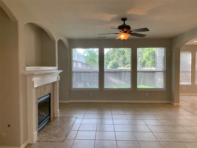 a view of empty room with windows and fan