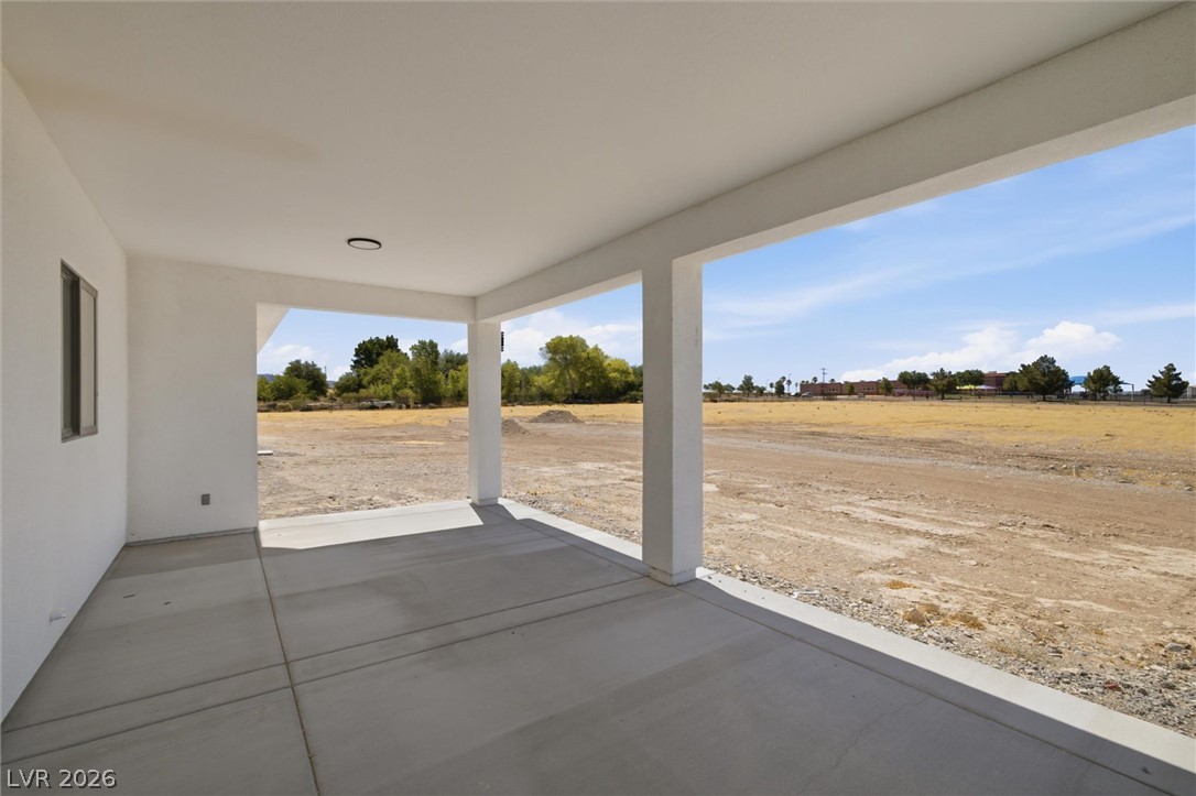 5910 East Kellogg Road Pahrump, NV 89061 - Photo 40 of 58 A spacious covered patio offers a refreshing respite with broad views of the open landscape.