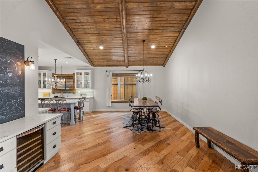 855 Conklin Road Big Bear Lake, CA 92315 - Photo 12 of 44 an open kitchen with dining room and wooden floor