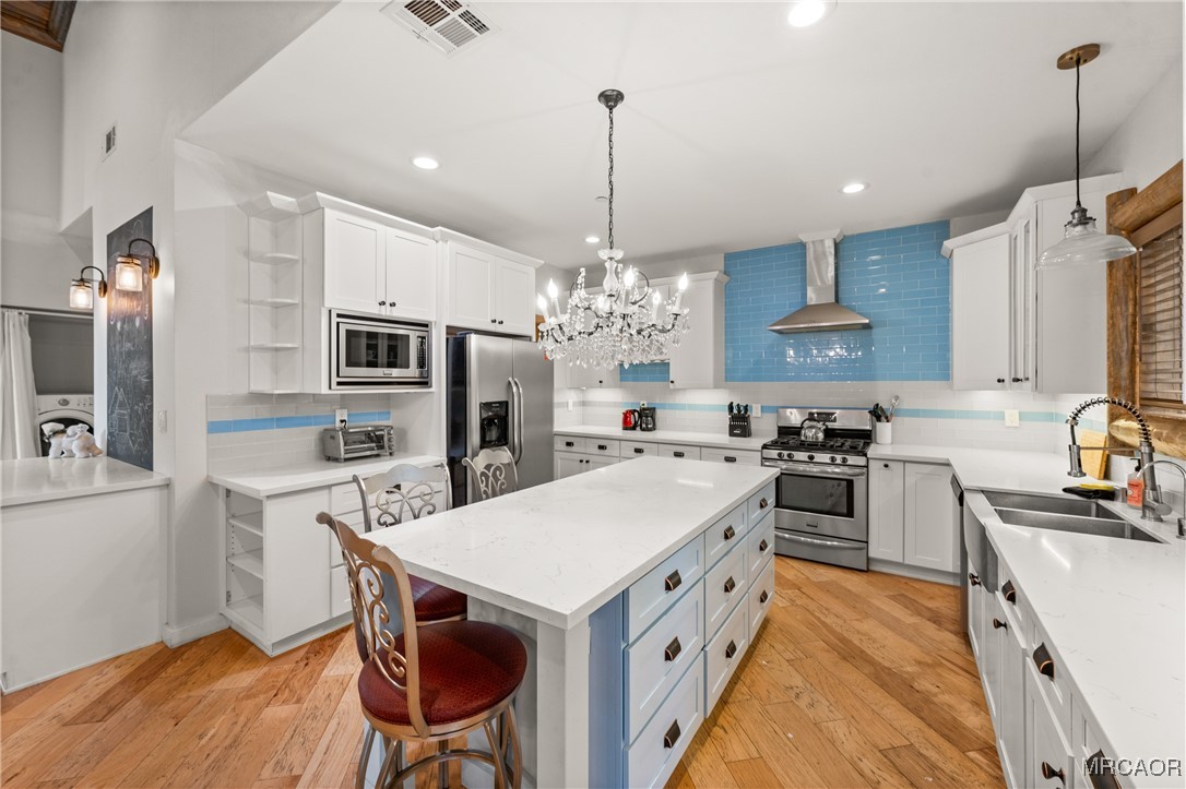 855 Conklin Road Big Bear Lake, CA 92315 - Photo 14 of 44 a kitchen that has a lot of cabinets in it and stainless steel appliances