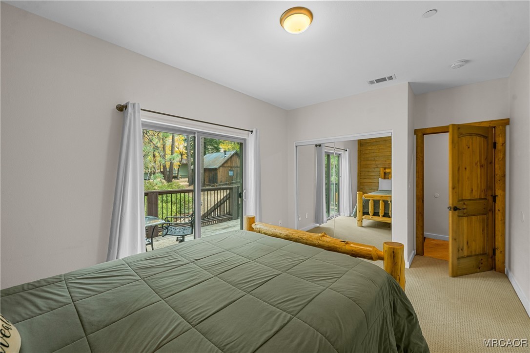 855 Conklin Road Big Bear Lake, CA 92315 - Photo 29 of 44 a bedroom with a bed and large windows