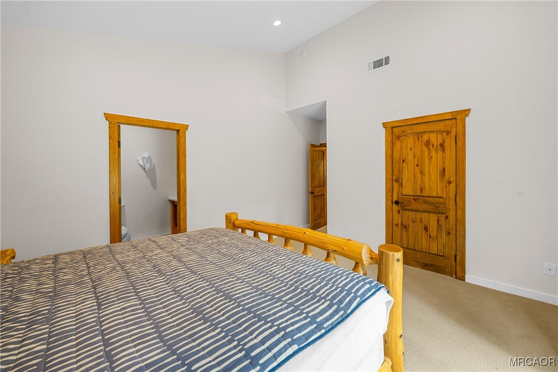 855 Conklin Road Big Bear Lake, CA 92315 - Photo 32 of 44 a bedroom with a bed and wooden floor