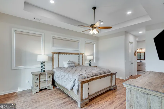 a bedroom with a bed and a chandelier