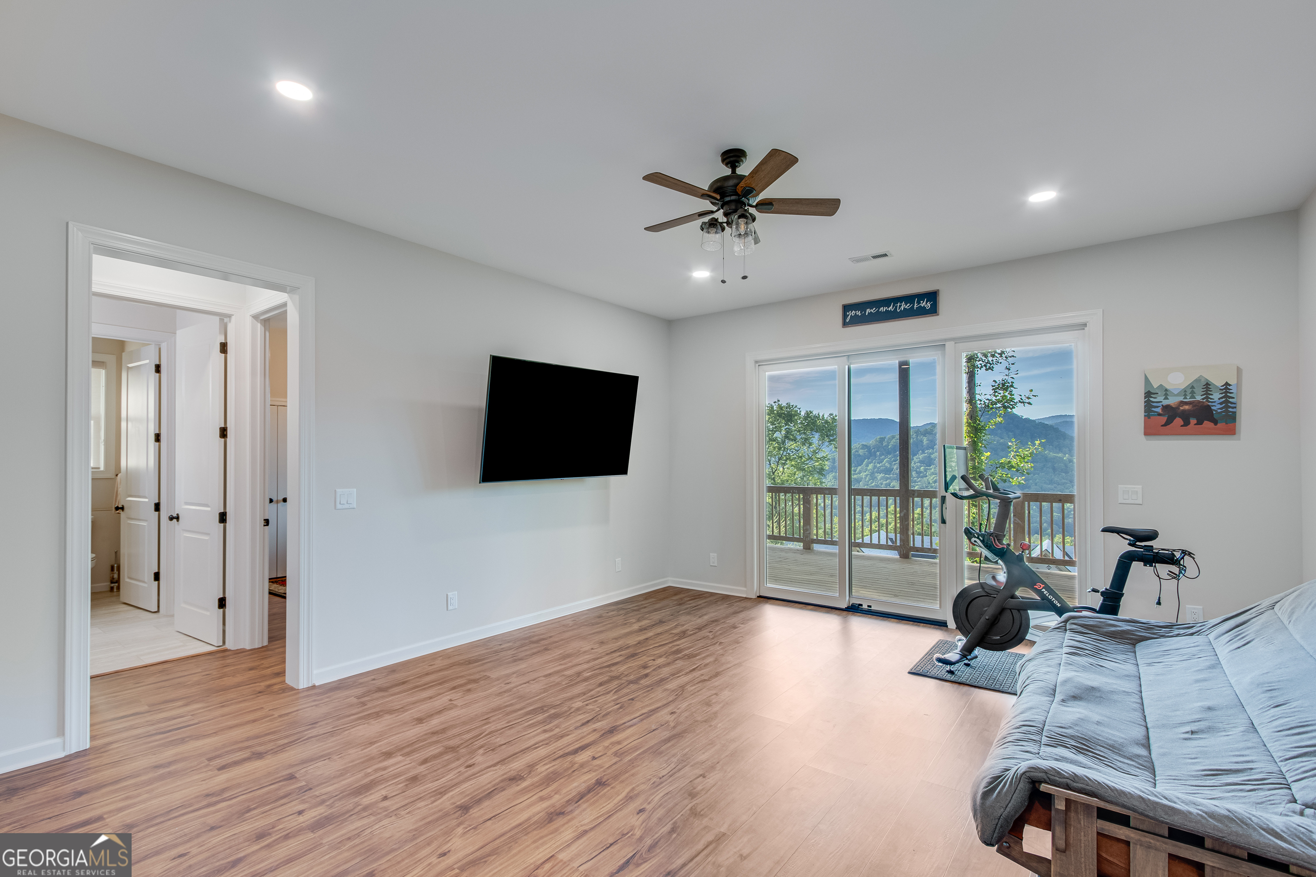 103 Bent Grass Way Clayton, GA 30525 - Photo 18 of 28 a living room with furniture a flat screen tv and a large window