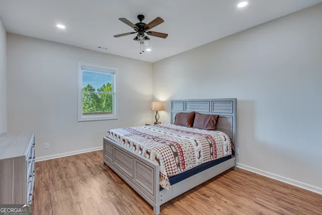 a bedroom with a bed and a chandelier