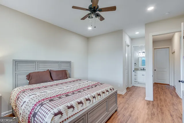 a bedroom with a large bed and a chandelier