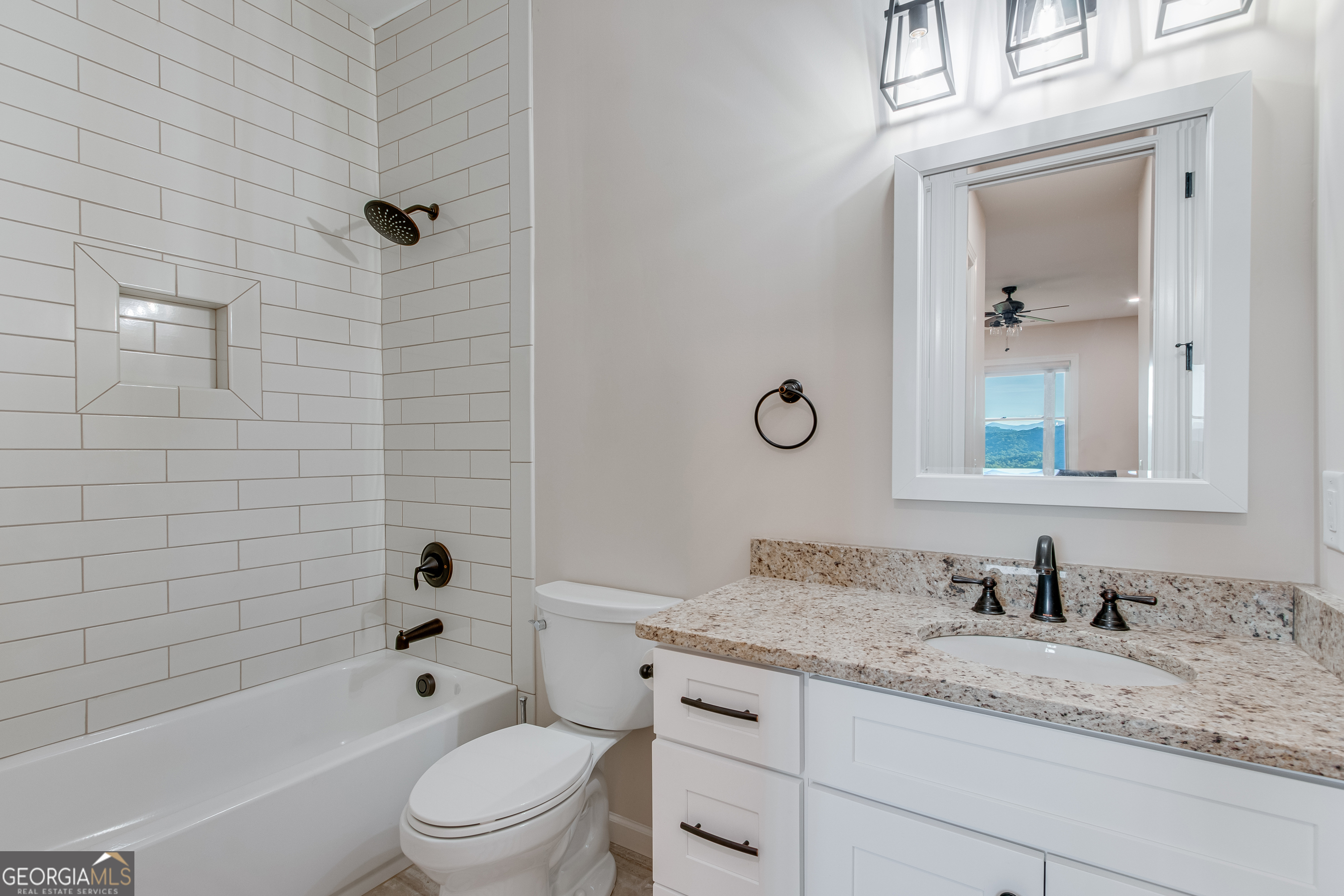103 Bent Grass Way Clayton, GA 30525 - Photo 24 of 28 a bathroom with a granite countertop toilet a sink and a bathtub