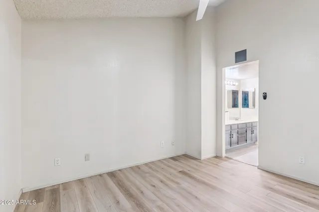 a bathroom with a granite countertop toilet sink and mirror