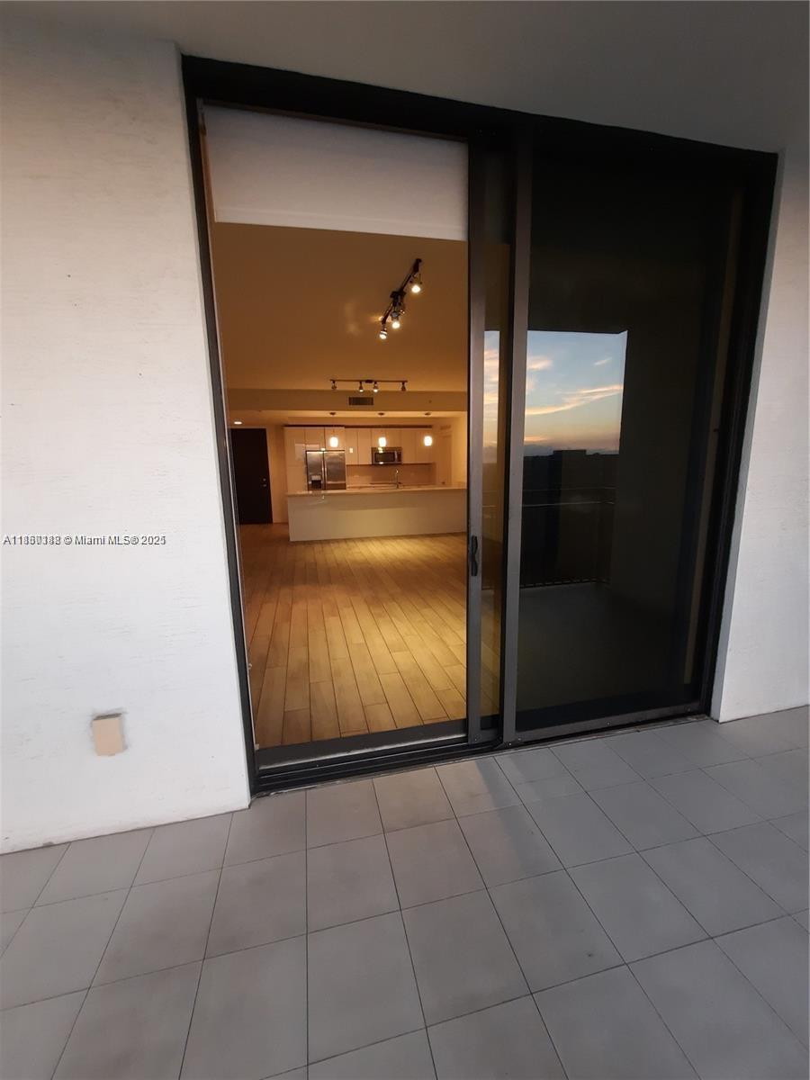 999 Southwest 1st Avenue, Unit 2705 Miami, FL 33130 - Photo 22 of 24 a view of a hallway with wooden door
