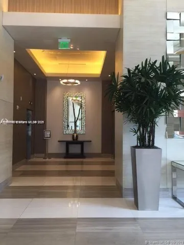a vase of flowers sitting on a table with window