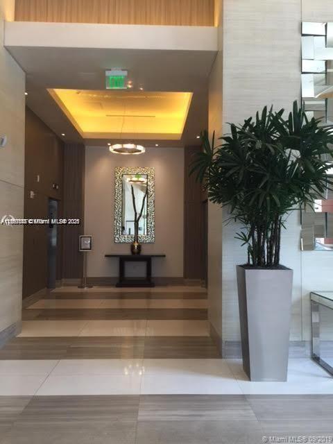 999 Southwest 1st Avenue, Unit 2705 Miami, FL 33130 - Photo 7 of 24 a view of entryway and hall with wooden floor