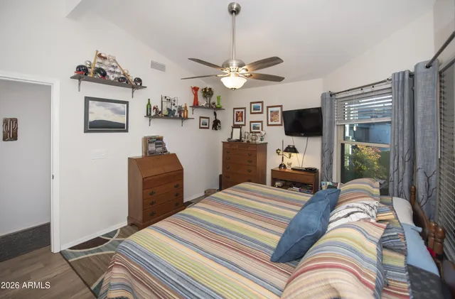 a bedroom with a bed and ceiling fan