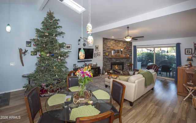 a living room with furniture a flat screen tv and a fireplace