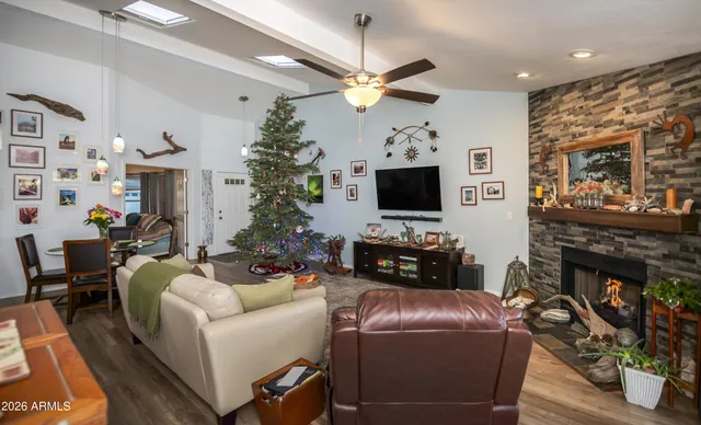 a living room with furniture a fireplace and a flat screen tv