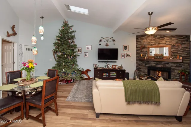 a living room with furniture a chandelier and a flat screen tv