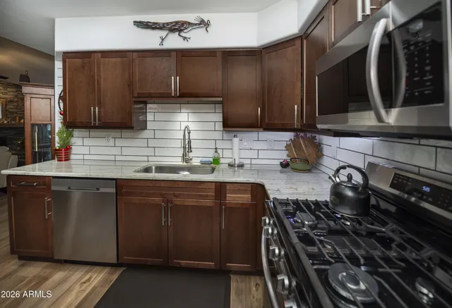a kitchen with wooden cabinets and a stove top oven