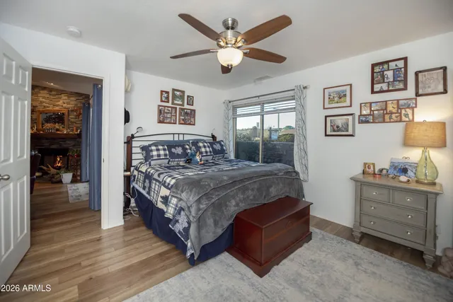 a bedroom with a large bed and a chandelier