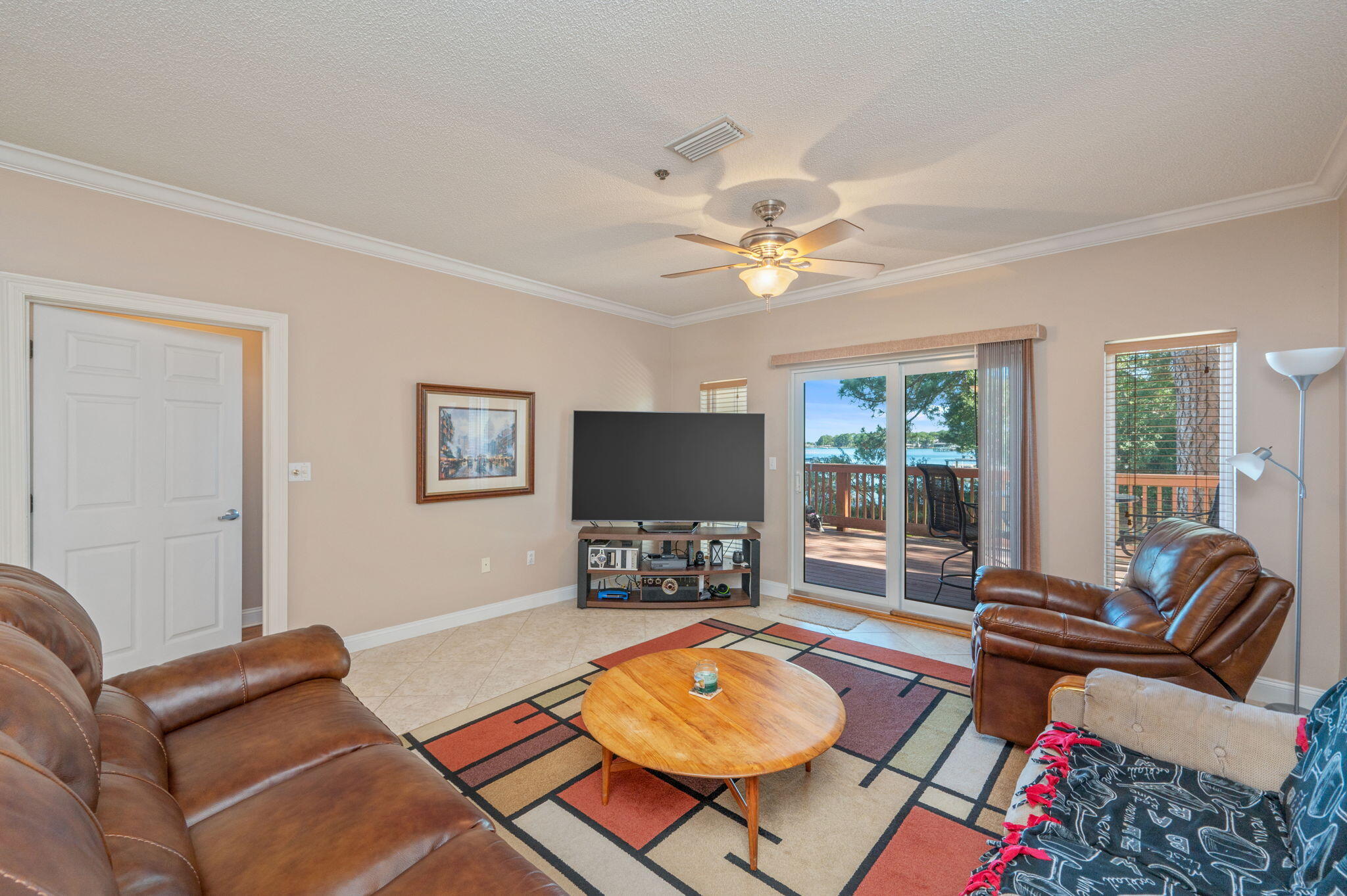 5 Laguna Street, Unit 104 Fort Walton Beach, FL 32548 - Photo 11 of 40 a living room with furniture and a flat screen tv with wooden floor
