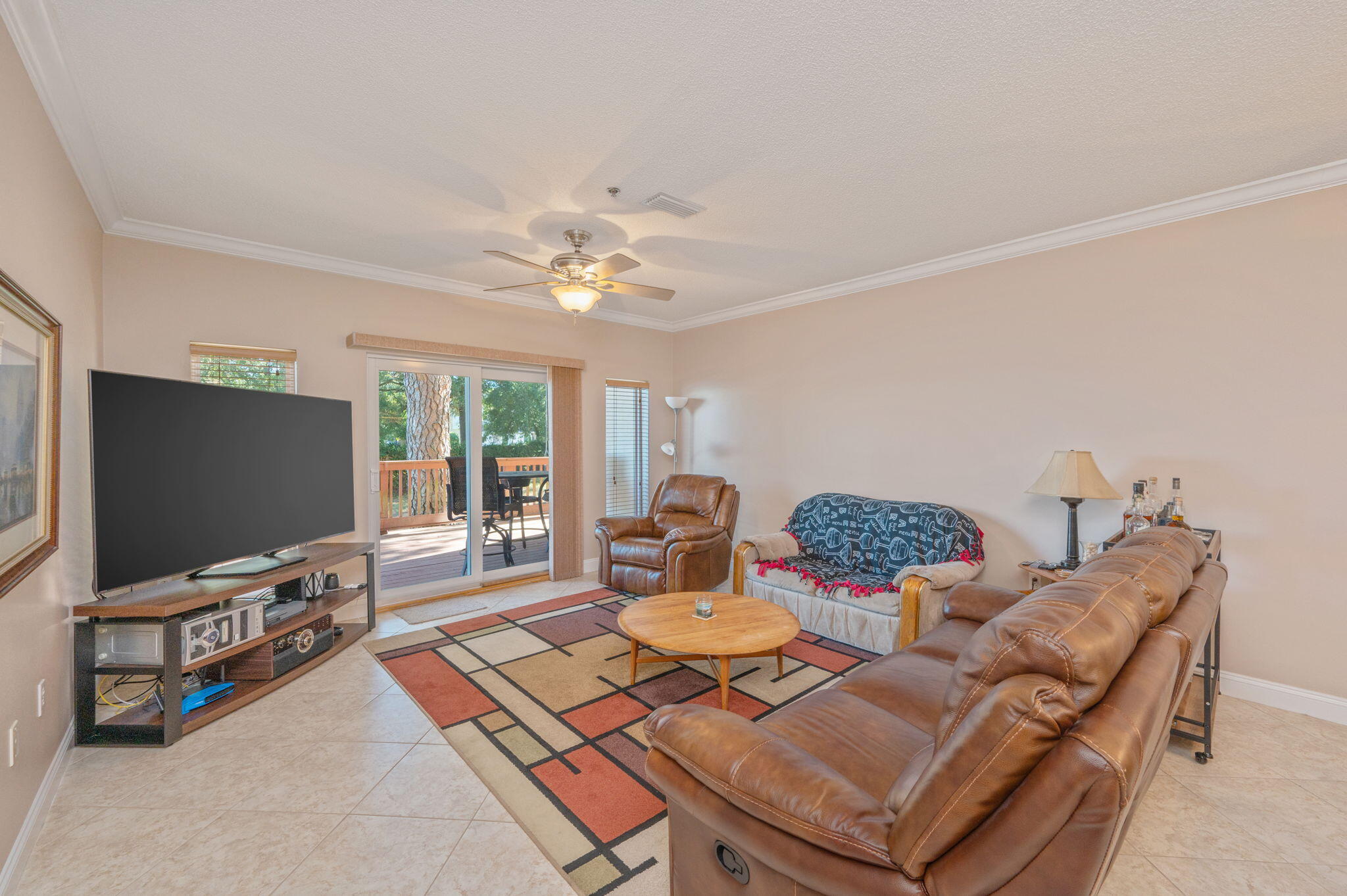 5 Laguna Street, Unit 104 Fort Walton Beach, FL 32548 - Photo 12 of 40 a living room with furniture and a flat screen tv