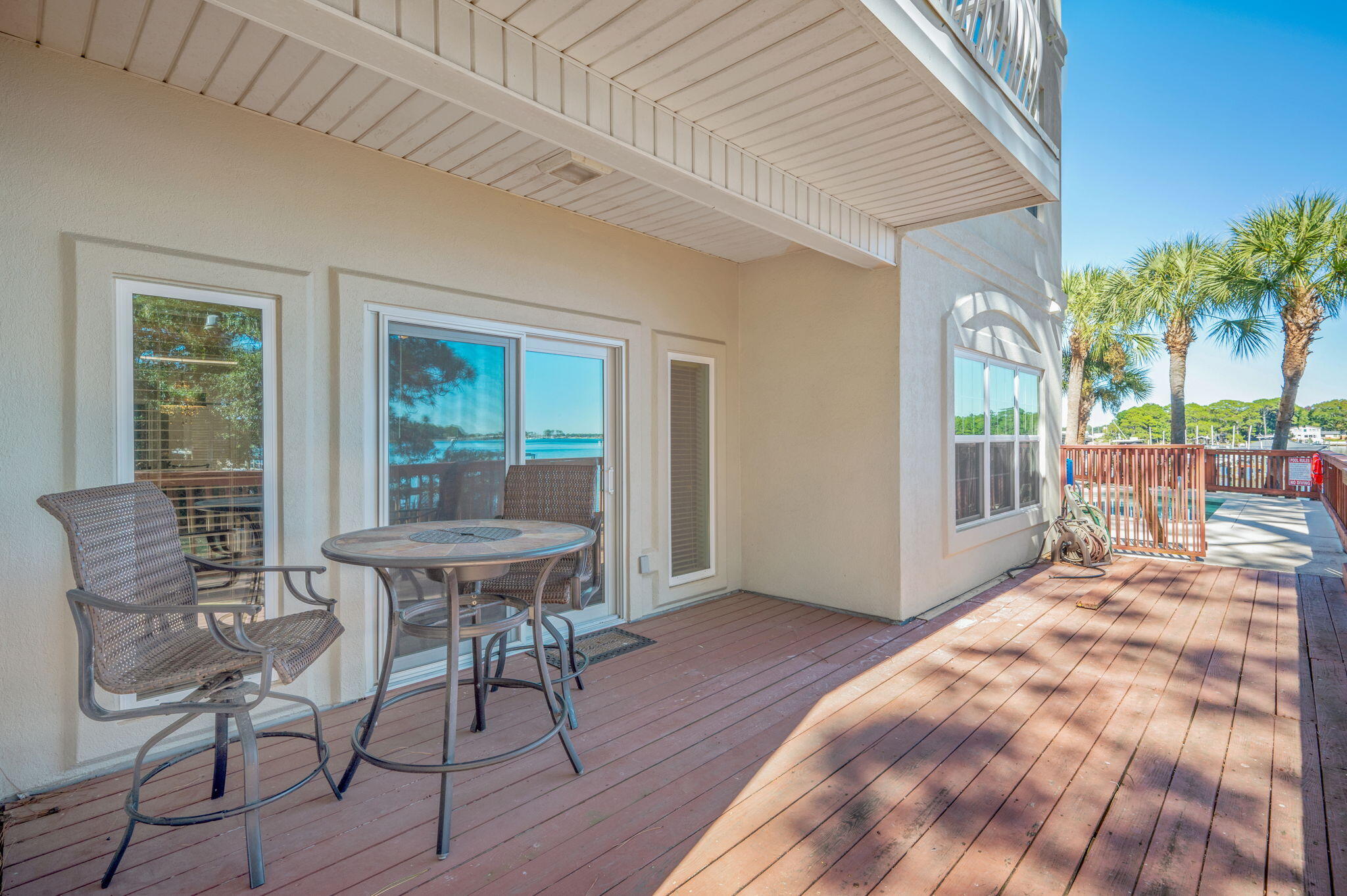 5 Laguna Street, Unit 104 Fort Walton Beach, FL 32548 - Photo 17 of 40 a patio with table and chairs and potted plants