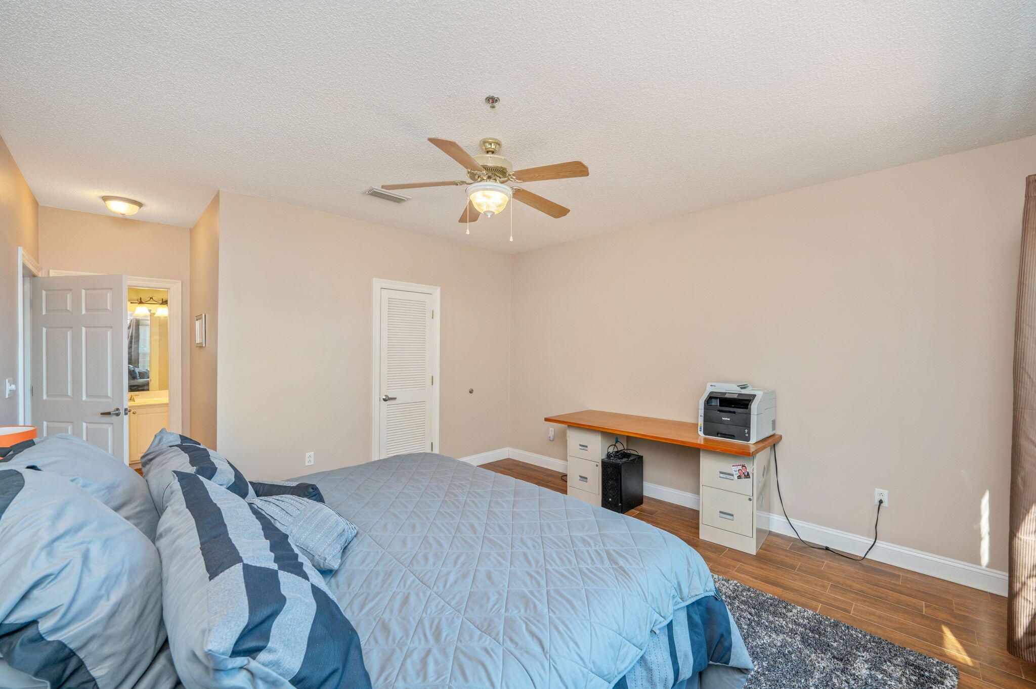 5 Laguna Street, Unit 104 Fort Walton Beach, FL 32548 - Photo 18 of 40 a bedroom with a bed and a chandelier