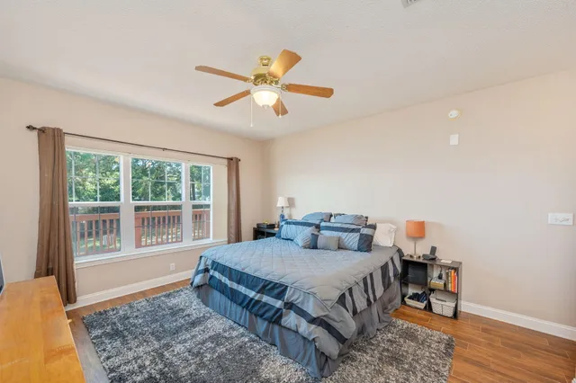 a bedroom with a bed and wooden floor