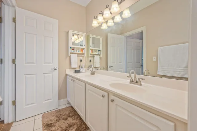 a bathroom with a double vanity sink and a mirror