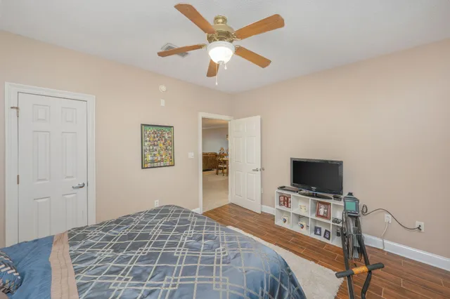 a bedroom with a bed and a flat screen tv
