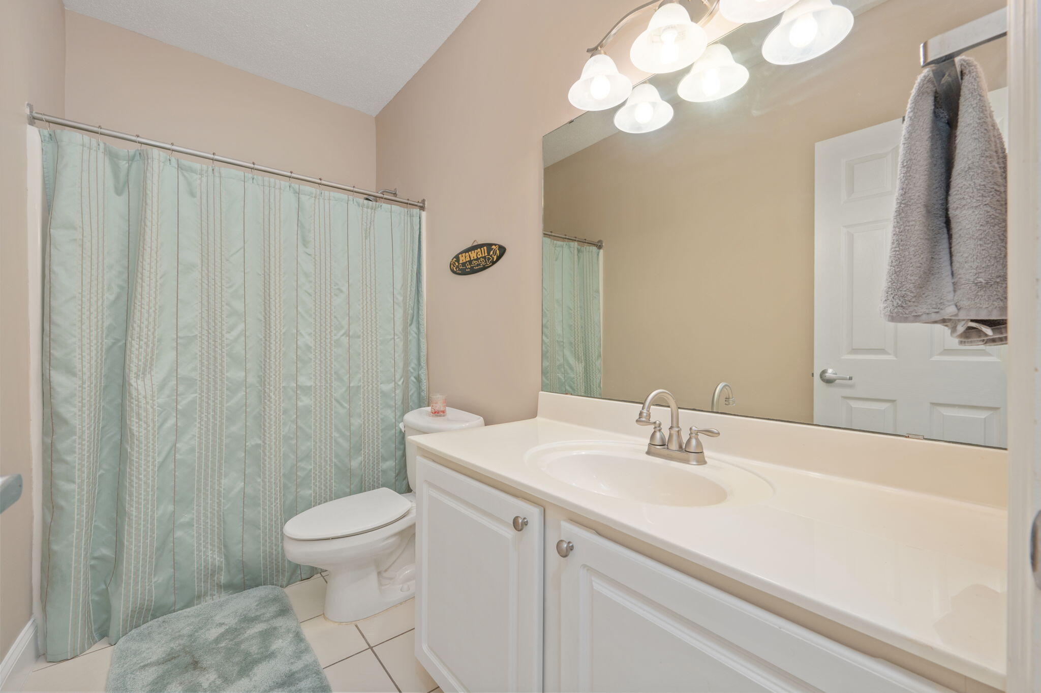 5 Laguna Street, Unit 104 Fort Walton Beach, FL 32548 - Photo 27 of 40 a bathroom with a sink a toilet and a mirror