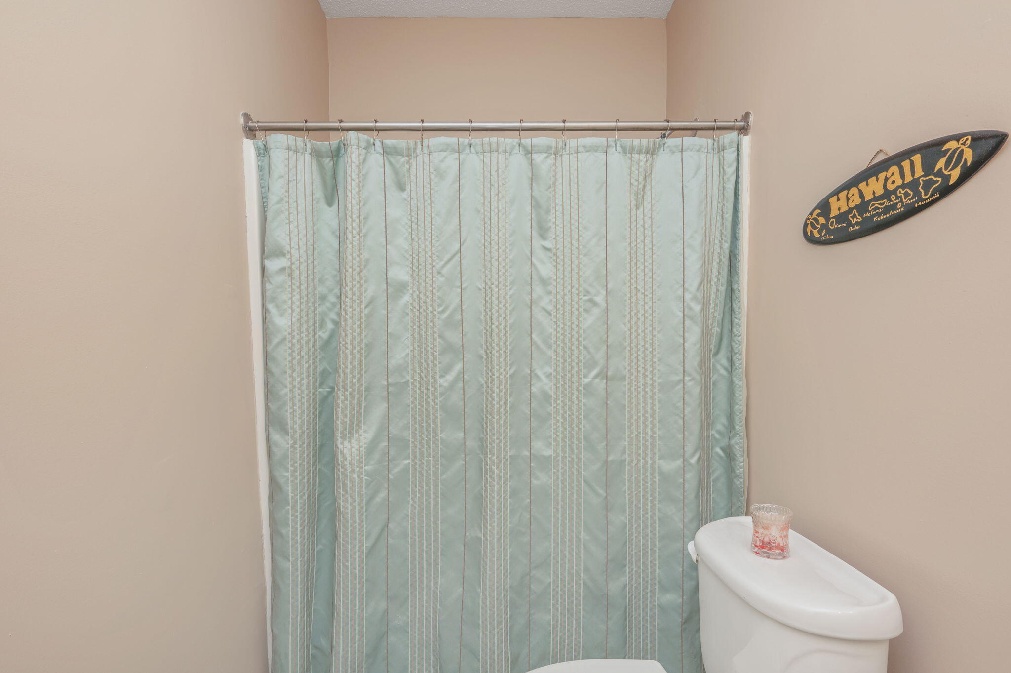 5 Laguna Street, Unit 104 Fort Walton Beach, FL 32548 - Photo 28 of 40 a bathroom with a shower curtain and a toilet