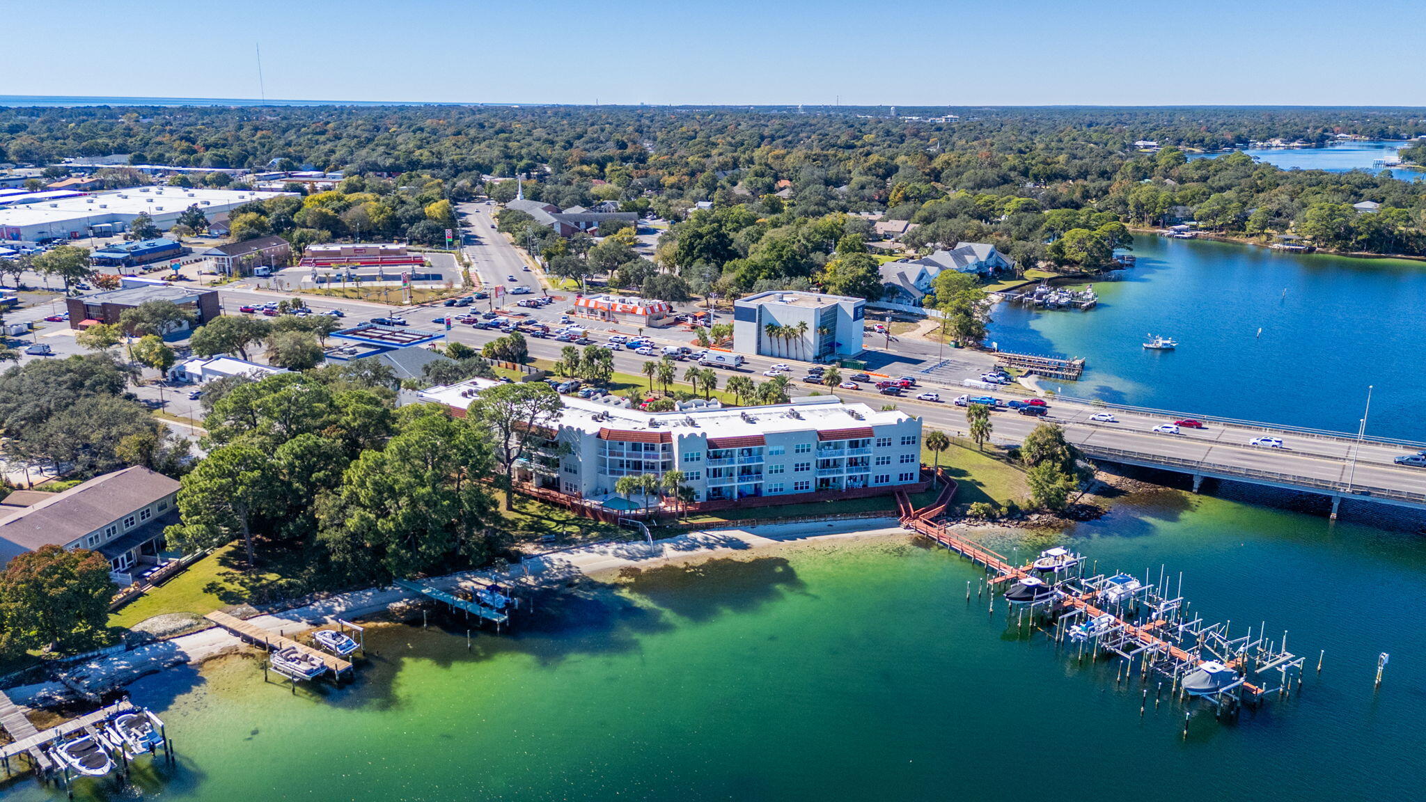 5 Laguna Street, Unit 104 Fort Walton Beach, FL 32548 - Photo 38 of 40 an aerial view of a house with a garden and lake view