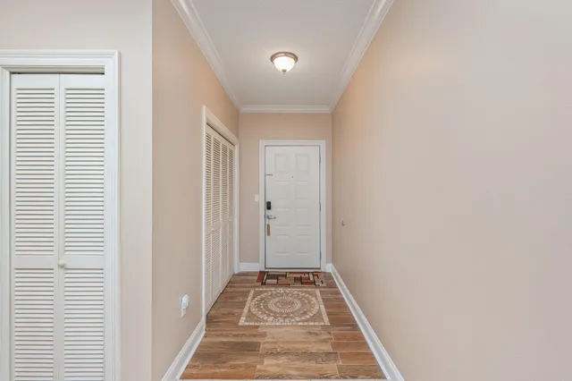 a view of a room with wooden floor and windows